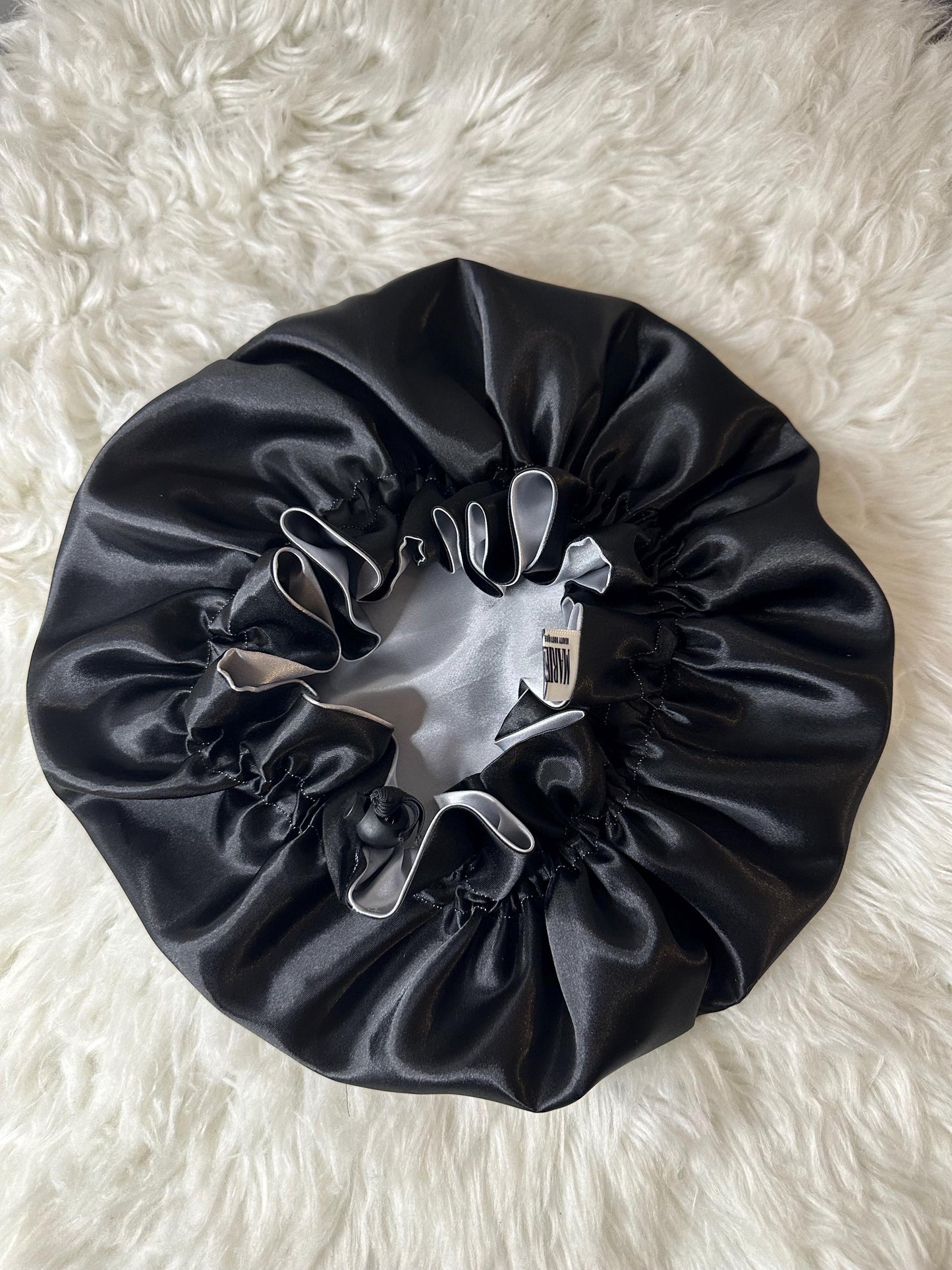 Handmade reversible satin bonnet in black and silver with an adjustable clasp for custom fit by mariebeauteeco