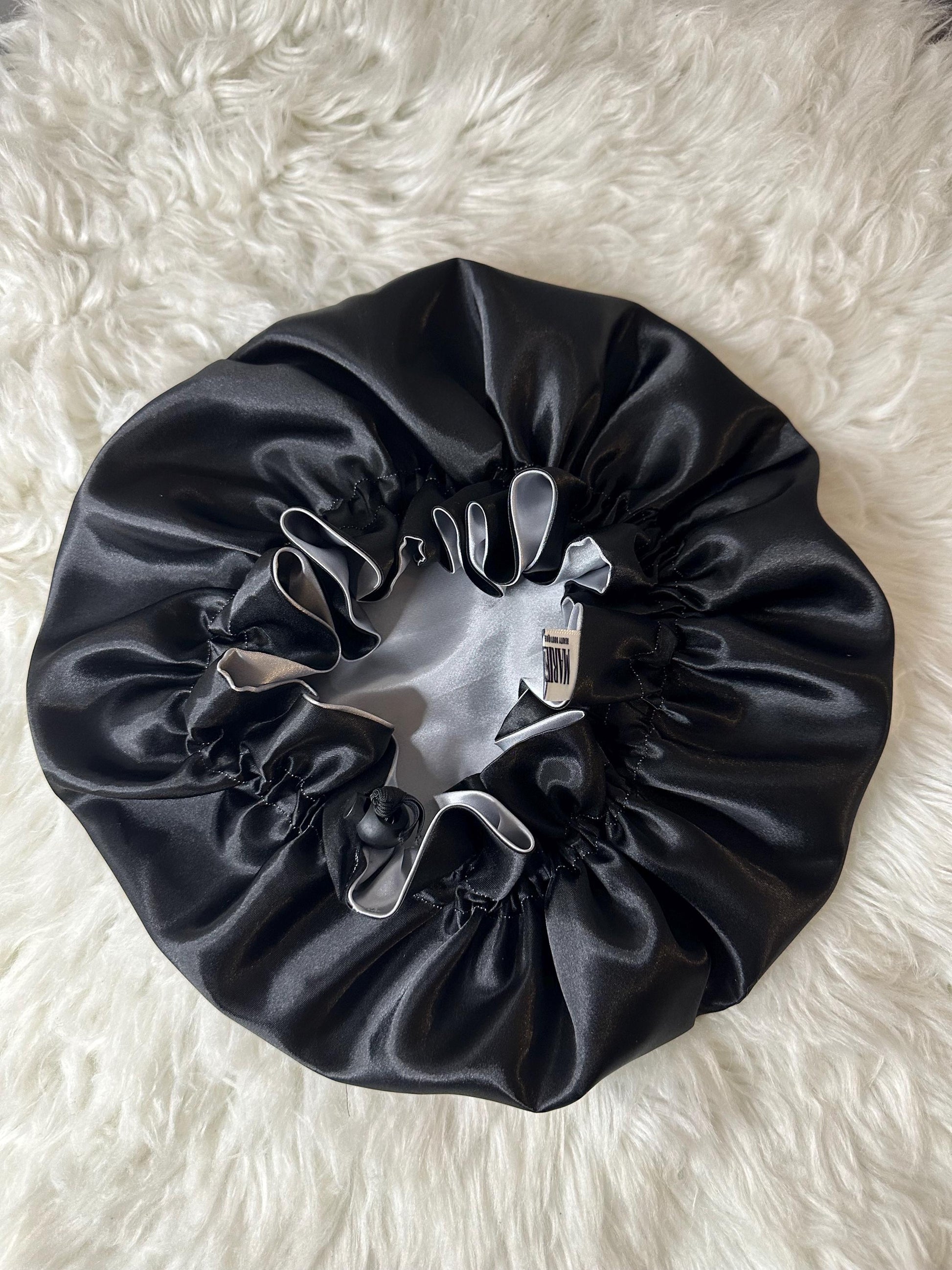Handmade reversible satin bonnet in black and silver with an adjustable clasp for custom fit by mariebeauteeco