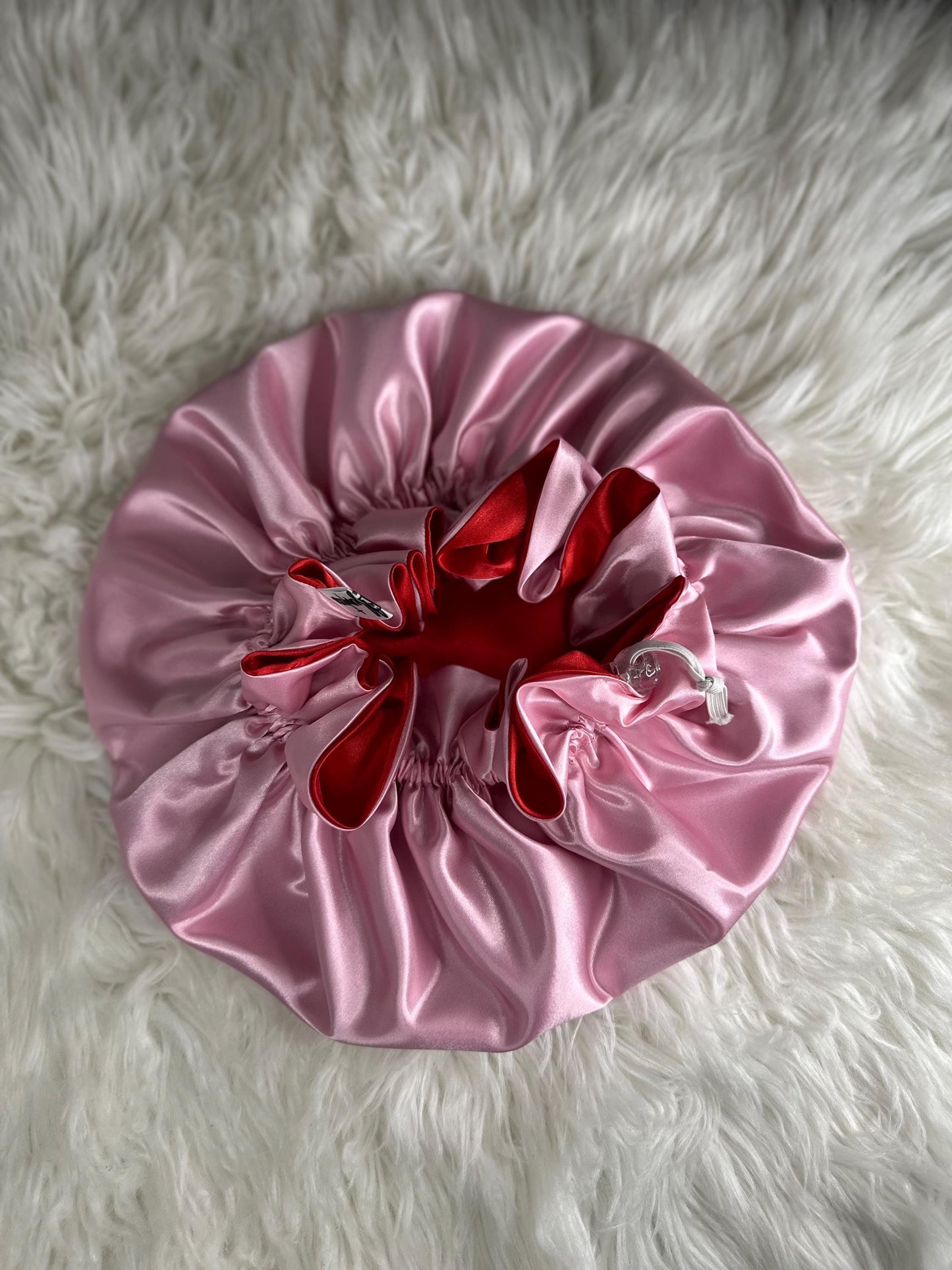 Handmade reversible satin bonnet in red and pink with an adjustable clasp for custom fit by mariebeauteeco